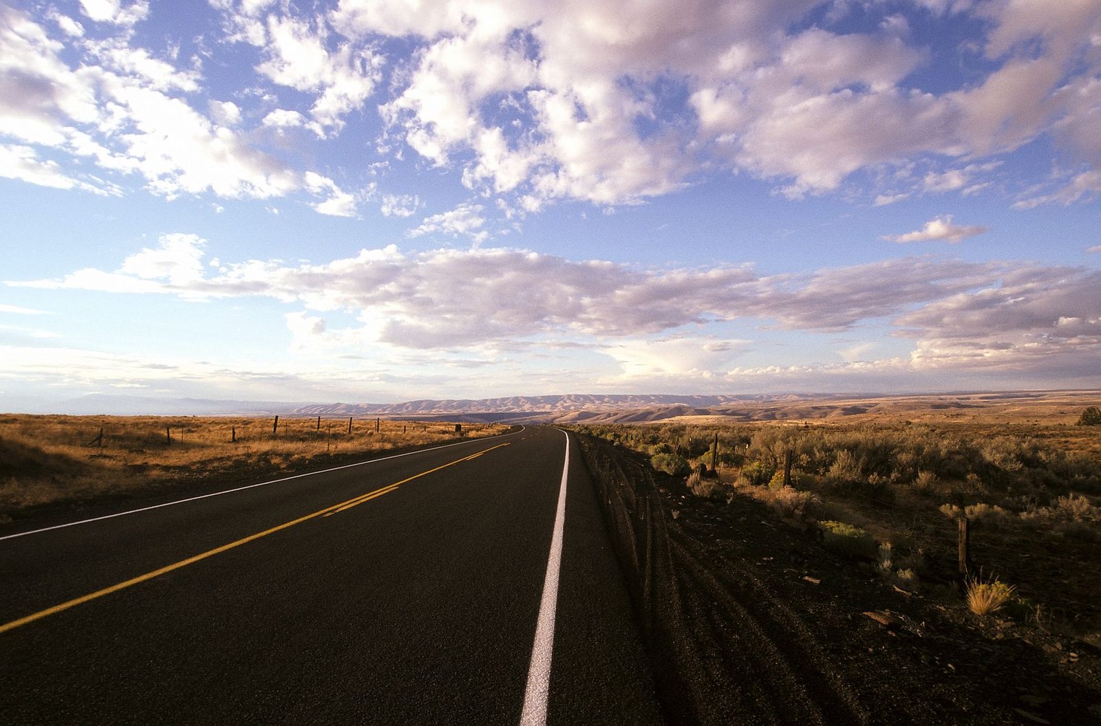 Open road through the Oregon landscape under a dramatic sky